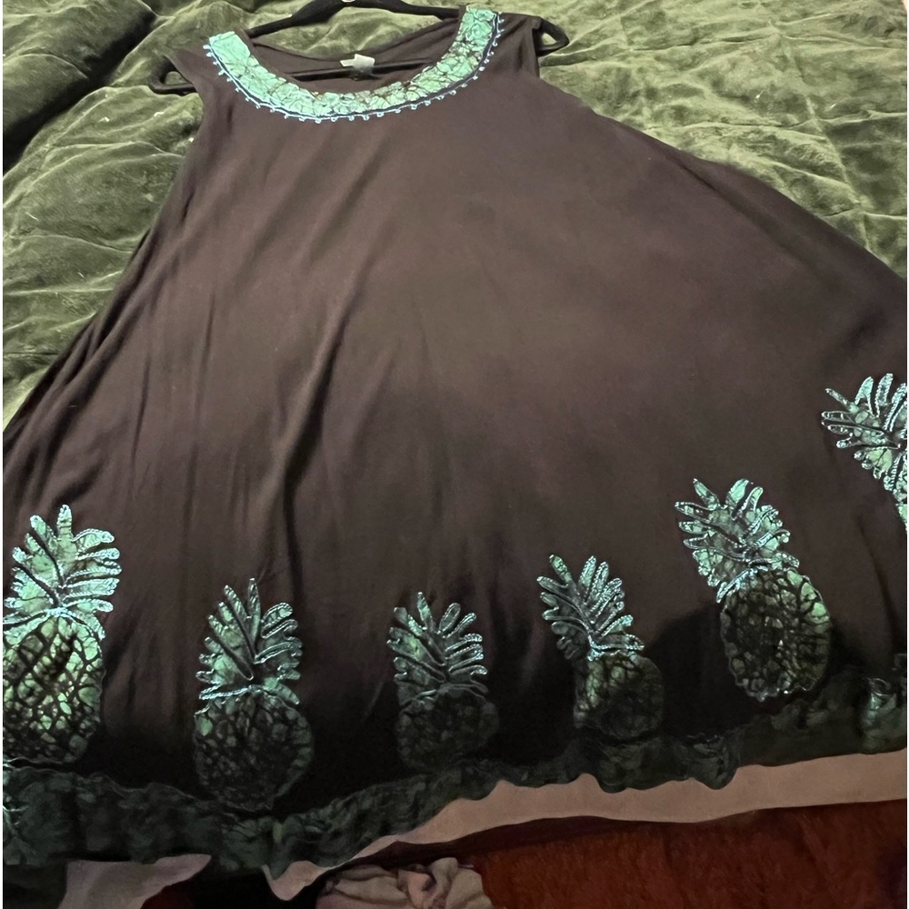Beautiful black dress with teal design around the bottom.